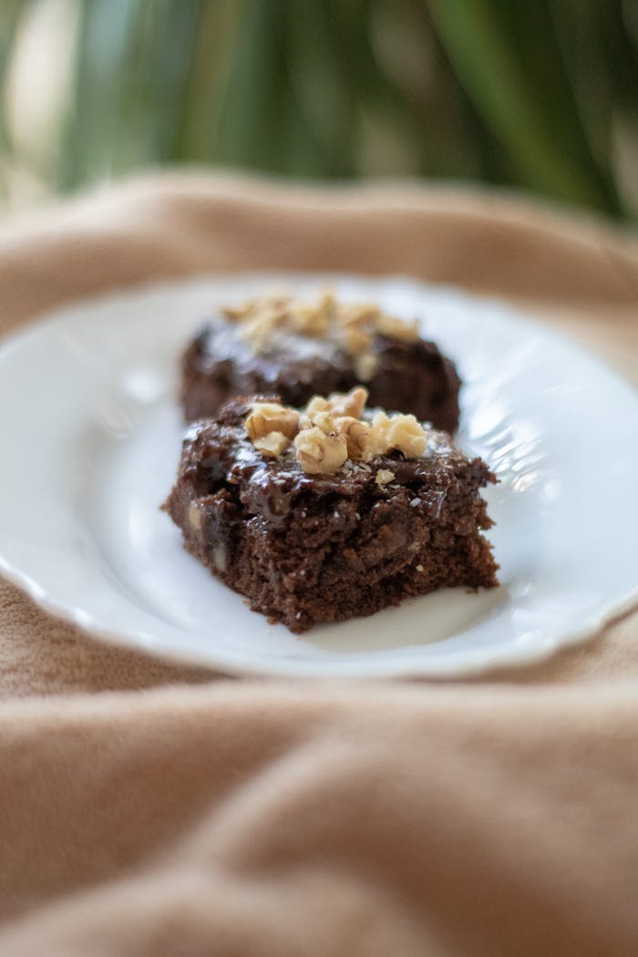 Close-up of scrumptious chocolate brownies topped with walnuts, perfect for dessert lovers.